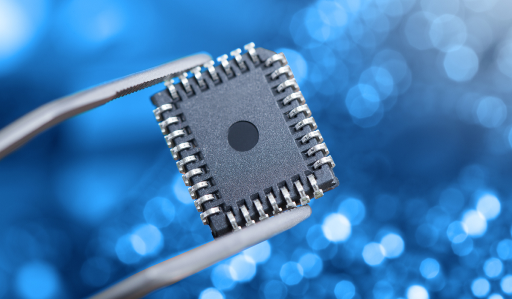 microchip processor being held in a pair of tweezers