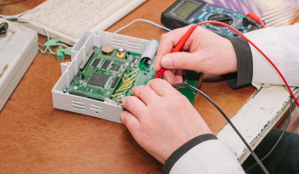 Technician affixing microchip to a circuit board