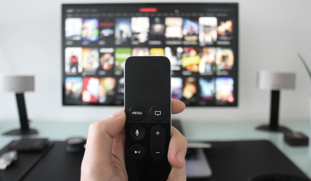 A TV remote control being pointed at a television