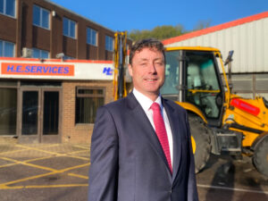 Brendan Walsh in front of a digger