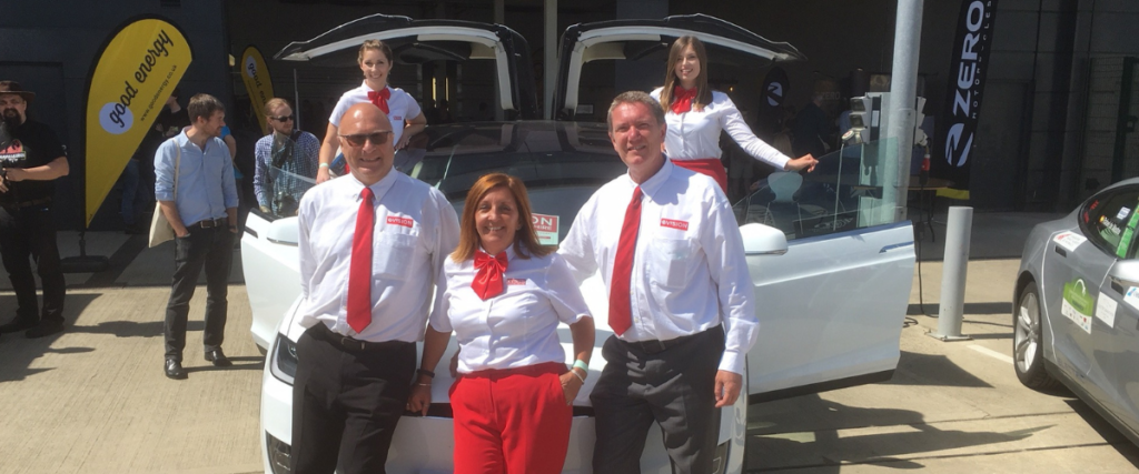 EVision team with a white Tesla Model X