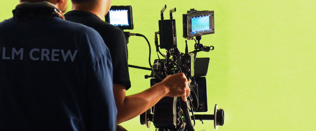 Camera operators filming a green screen