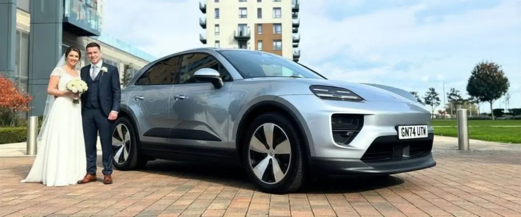 Wedding car Porsche Macan with wedding couple
